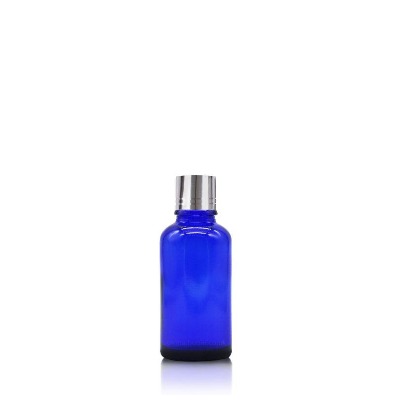 an empty 30ml capacity blue glass bottle with a silver screw cap on a white background